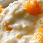 Appelsiiniriisi lasikulhossa appelsiinilohkoilla koristeltuna
